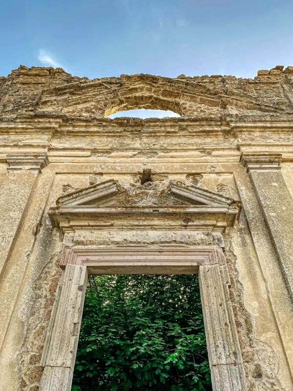 Antica Monterano particolare del portale sormontato da oculo della facciata della chiesa di San Bonaventura nel borgo fantasma